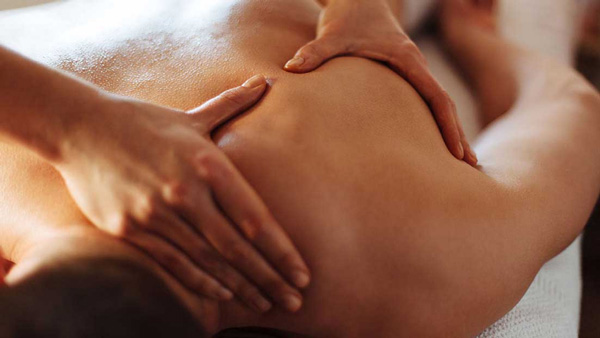 woman's hands making massage to a male model